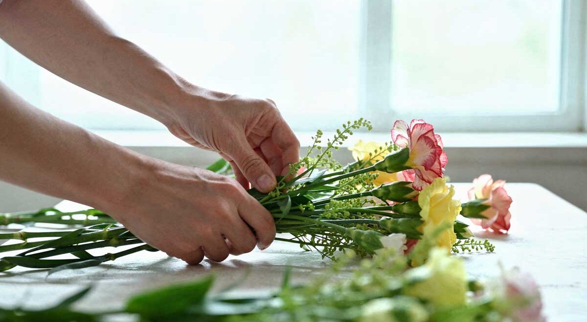 Local florist hand-crafting a custom bouquet in the Salisbury Flower Shop studio