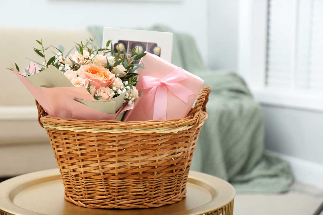 Gift basket with flowers and treats available at Salisbury Flower Shop